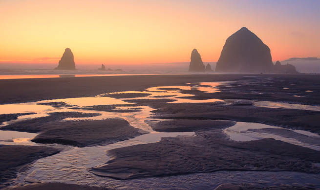 Haystack Rock reaches into the sky near Cannon Beach, Oregon.